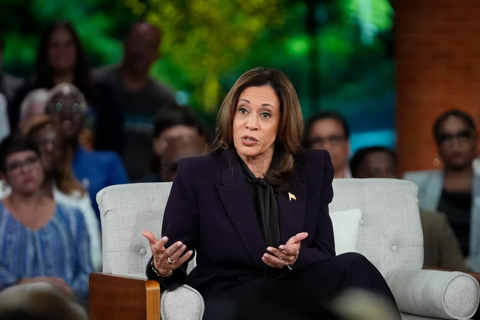 Democratic presidential nominee Vice President Kamala Harris answers an audience member's question as she joins Oprah Winfrey at Oprah's Unite for America Live Streaming event Thursday, Sept. 19, 2024 in Farmington Hills, Mich. (AP Photo/Paul Sancya)