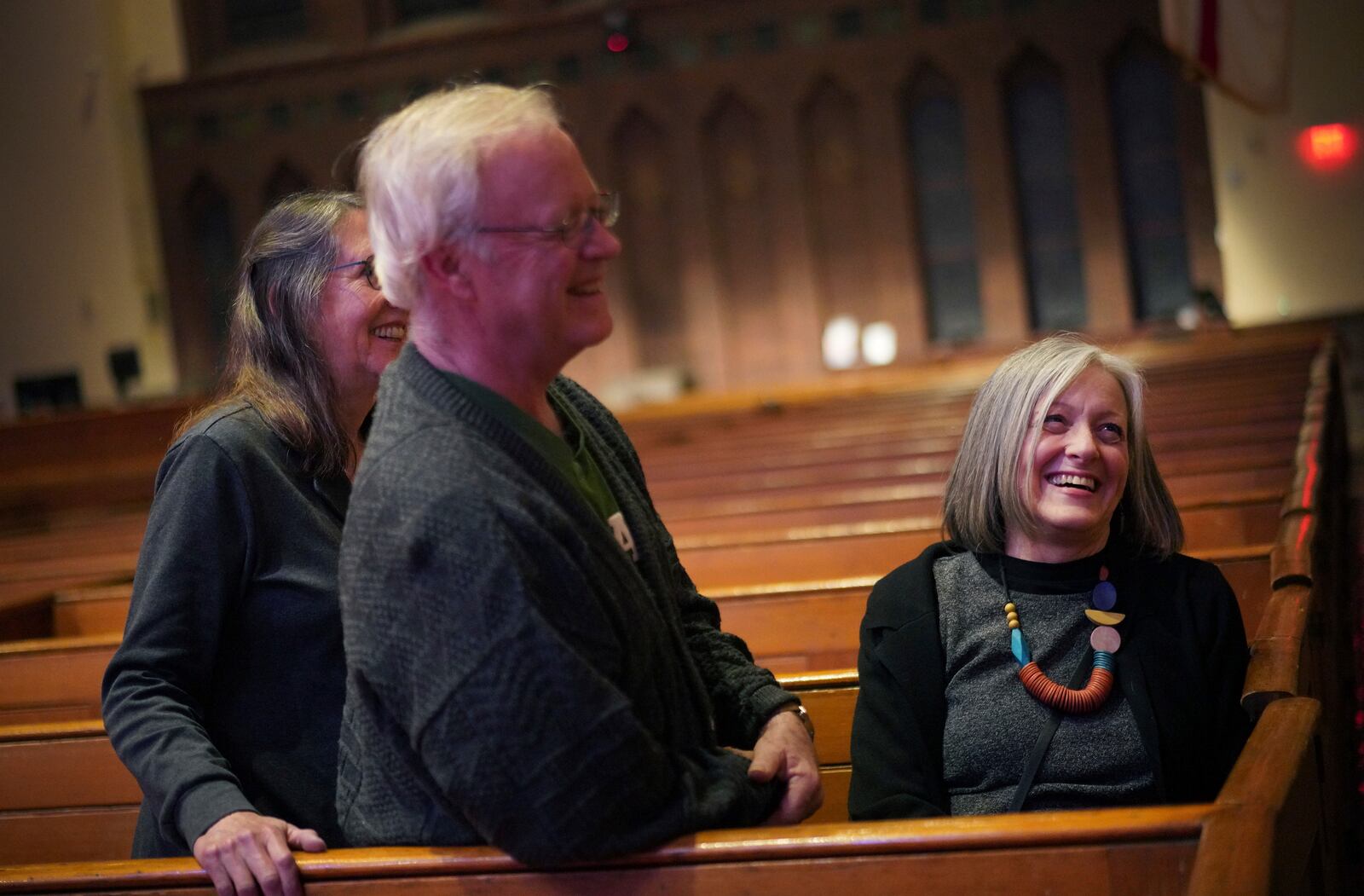 Susan Bickel, left, David Bickel, and Connie Hazeltine share a laugh after a "Contemplative Citizenship" service at St. James Episcopal Church in Lancaster, Pa., on Tuesday, Oct. 15, 2024. (AP Photo/Jessie Wardarski)