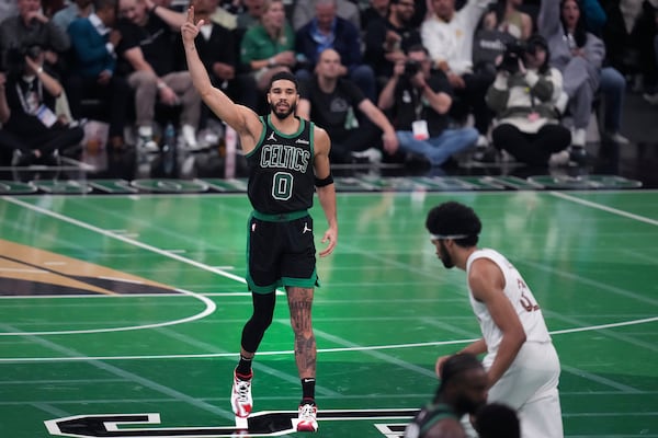 Boston Celtics forward Jayson Tatum (0) celebrates after hitting a 3-pointer during the second half of an Emirates NBA Cup basketball game against the Cleveland Cavaliers, Tuesday, Nov. 19, 2024, in Boston. (AP Photo/Charles Krupa)