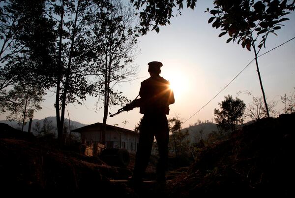 FILE- A Kachin Independence army rebel stands at frontline outpost facing no man's land in Lawa Yang, outside of Laiza, the armed group's headquarters in northern Kachin state, Myanmar, March 20, 2018. (AP Photo/Esther Htusan, File)