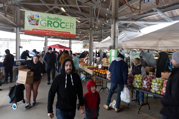 Shoppers make their way past vendors at the Rochester Public Market on Saturday, March 22, 2025, in Rochester, N.Y. (Caitlyn Daproza via AP)