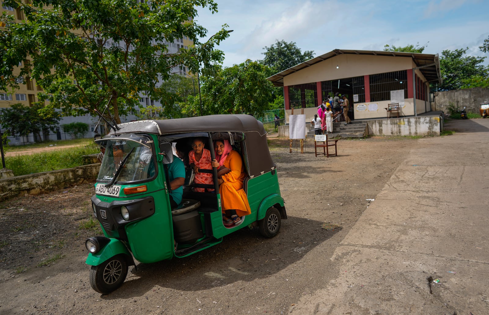 A Sri Lankan family sit in a rickshaw as they leave a polling station after casting their votes in Colombo, Sri Lanka, Saturday, Sept. 21, 2024. (AP Photo/Eranga Jayawardena)