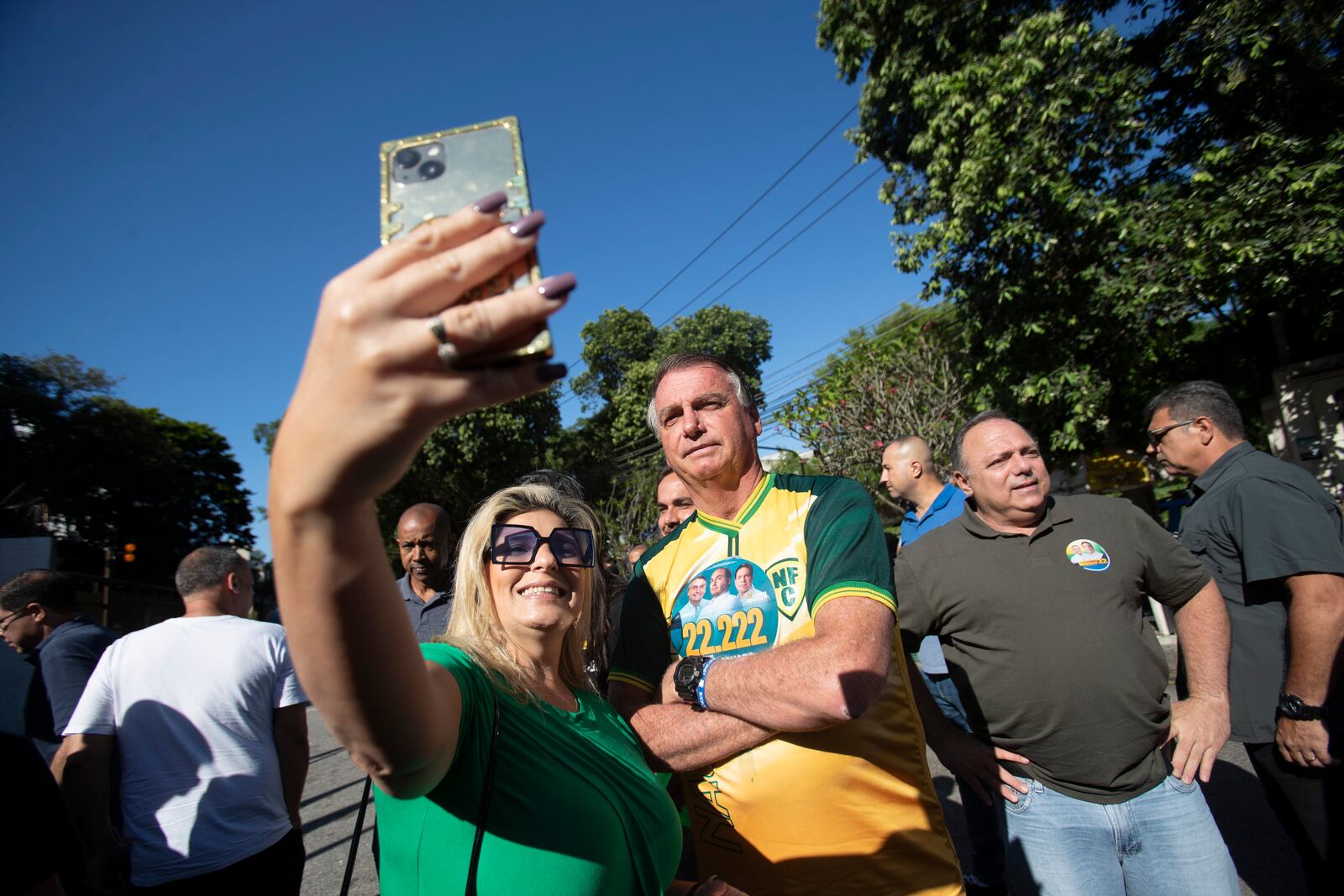 A supporter takes a selfie with former President Jair Bolsonaro as he accompanies Rio de Janeiro mayoral candidate Alexandre Ramagem during the municipal elections in Rio de Janeiro, Sunday, Oct. 6, 2024. (AP Photo/Bruna Prado)