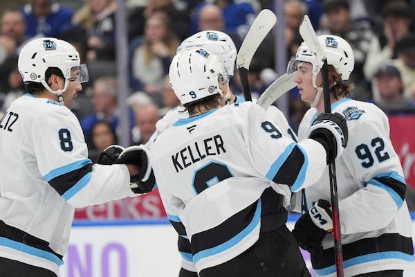 Utah Hockey Club centre Logan Cooley (92) celebrates his goal against the Toronto Maple Leafs with teammates during the first period of an NHL hockey game in Toronto, Sunday, Nov. 24, 2024. (Frank Gunn/The Canadian Press via AP)