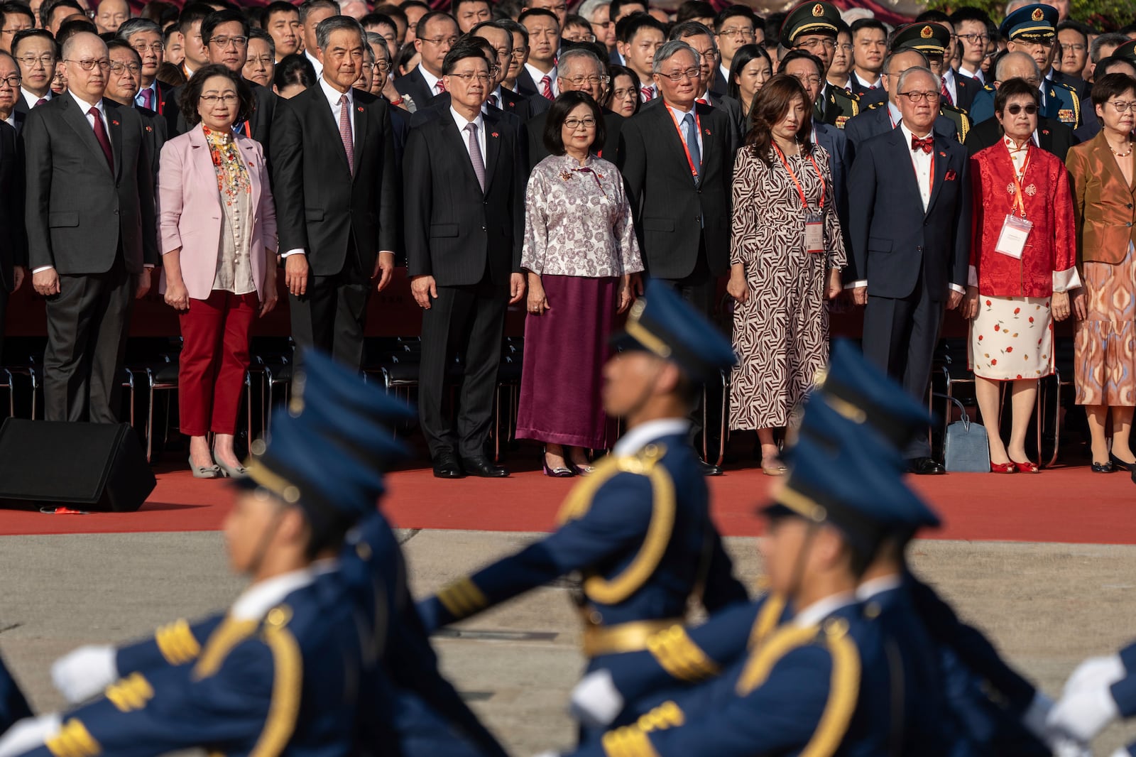 Hong Kong Chief Executive John Lee, fourth from left, and other officials attend a flag raising ceremony for the celebration of the 75th National Day of the People's Republic of China in Hong Kong, Tuesday, Oct. 1, 2024. (AP Photo/Chan Long Hei)