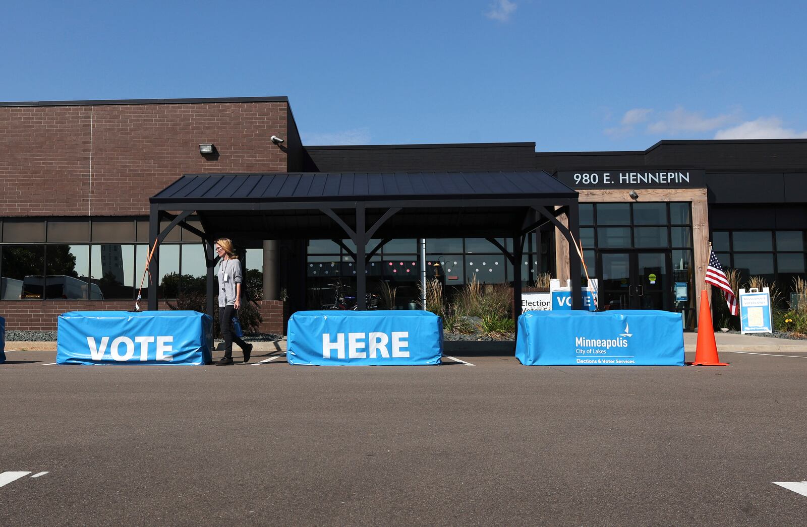 A member of the staff walks out of the City of Minneapolis early voting center, Thursday, Sept. 19, 2024, in St. Paul, Minn. In-person voting in the 2024 presidential contest begins Friday in three states, including Democratic vice presidential candidate Tim Walz's home state of Minnesota, with just over six weeks left before Election Day. (AP Photo/Adam Bettcher)