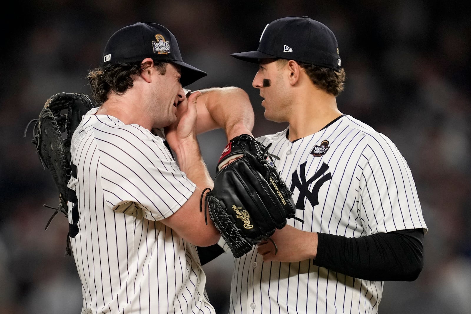 New York Yankees first baseman Anthony Rizzo (48) talks with starting pitcher Gerrit Cole during the fifth inning in Game 5 of the baseball World Series against the Los Angeles Dodgers, Wednesday, Oct. 30, 2024, in New York. (AP Photo/Ashley Landis)