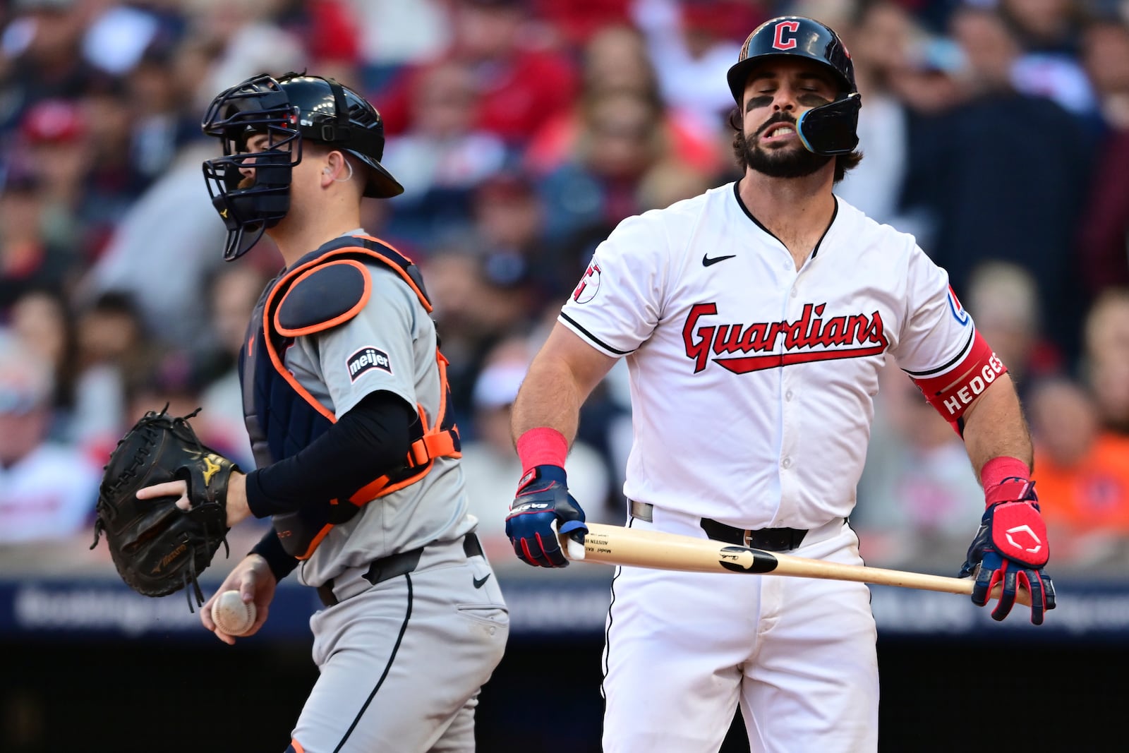 Cleveland Guardians' Austin Hedges, right, reacts after striking out in the third inning during Game 2 of baseball's AL Division Series against the Detroit Tigers, Monday, Oct. 7, 2024, in Cleveland. Tigers catcher Jake Rogers is at left. (AP Photo/David Dermer)