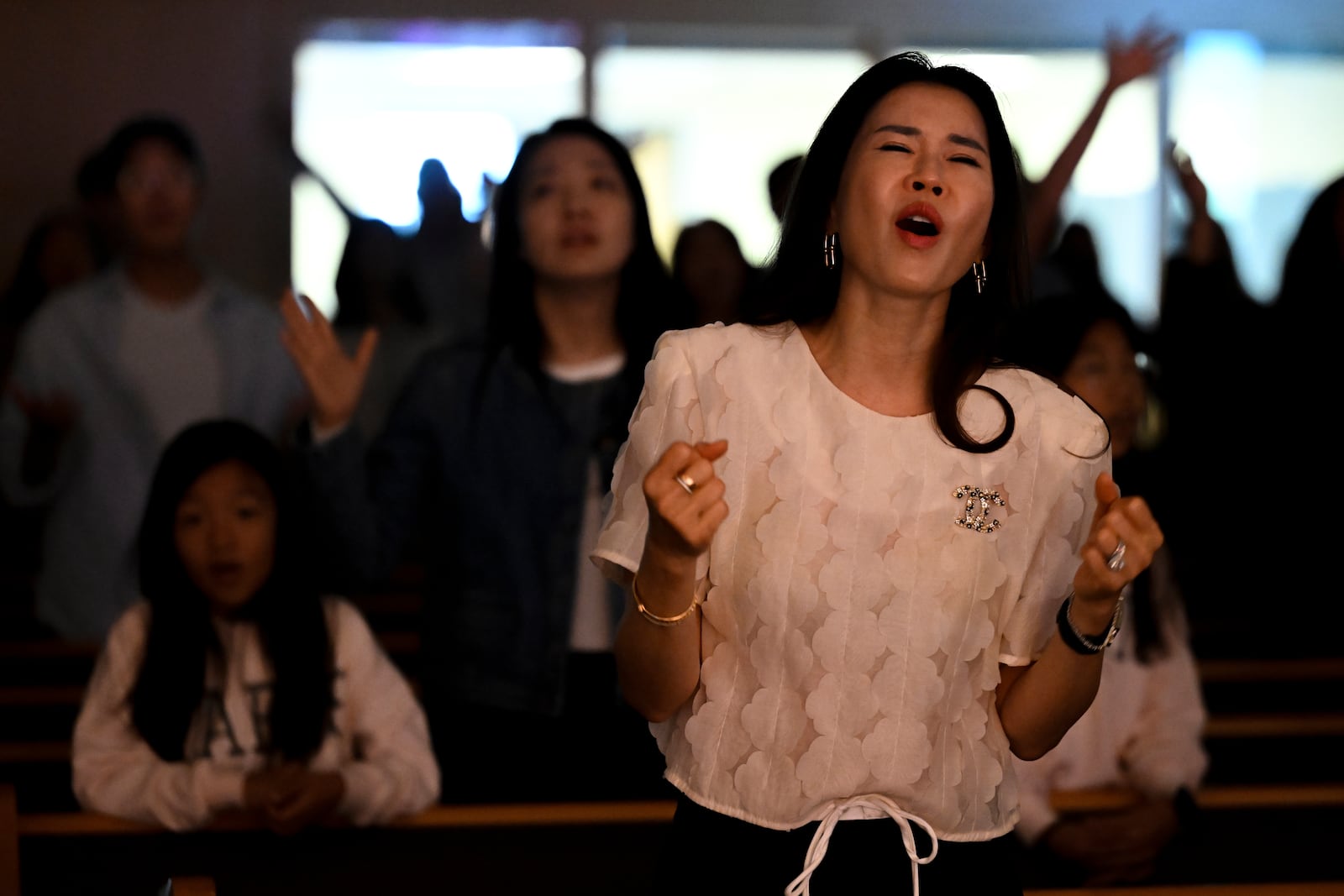 Joy Park prays during a service at the Christ Central Presbyterian Church, Sunday, Oct. 13, 2024 in Centreville. (AP Photo/John McDonnell)