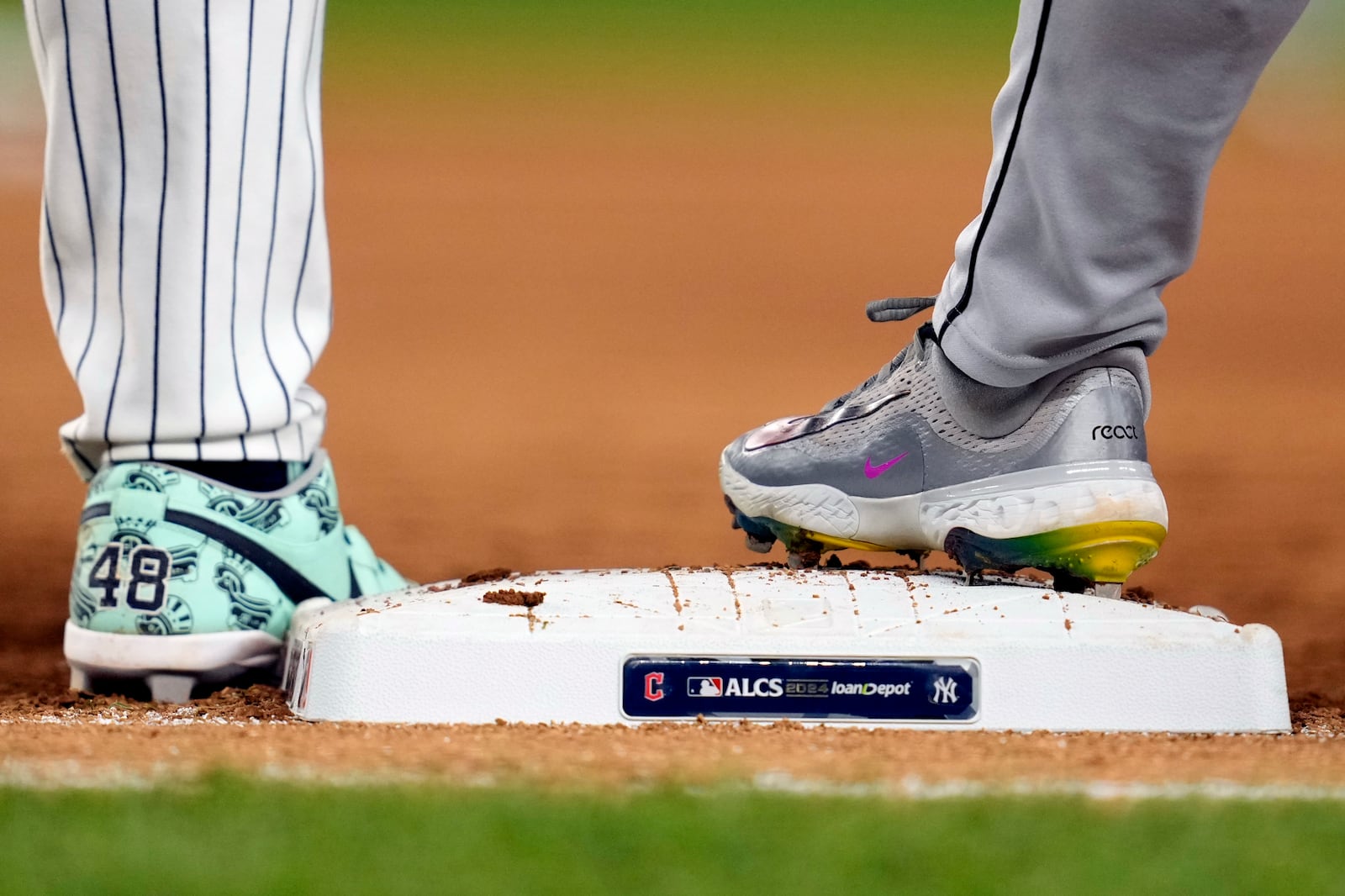 New York Yankees' Anthony Rizzo (48) and Steven Kwan stand at first base during the eighth inning in Game 1 of the baseball AL Championship Series Monday, Oct. 14, 2024, in New York. (AP Photo/Godofredo Vásquez)