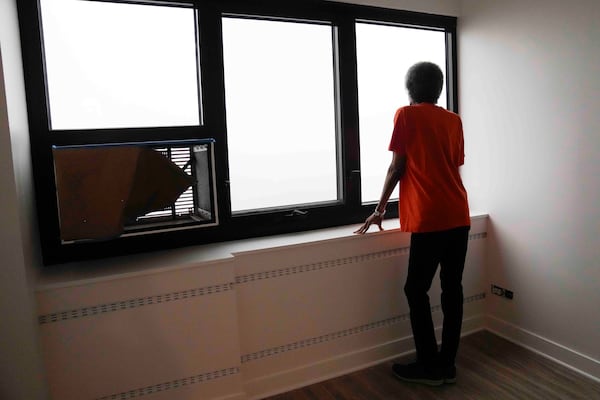 Bernadine Gibson, 82, looks out the window of a renovated unit in the building her family has lived in for 27 years Monday, Nov. 18, 2024, in Chicago. (AP Photo/Erin Hooley)