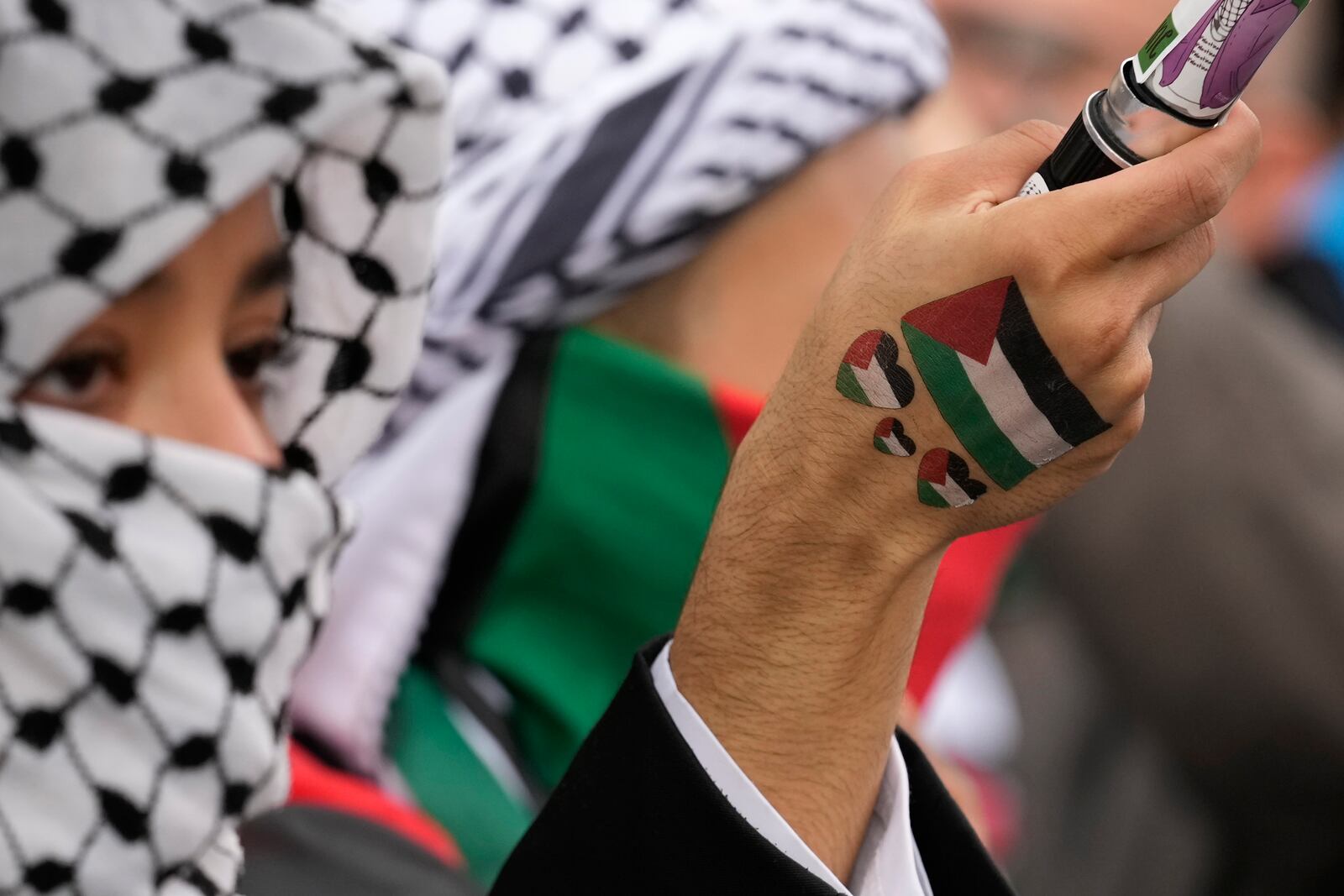 Women attend at a protest in Rome, Saturday, Oct. 5, 2024. Pro-palestinians people take to the street in an unauthorised march in the centre of Rome two days ahead of the first anniversary of the Oct. 7. (AP Photo/Andrew Medichini)