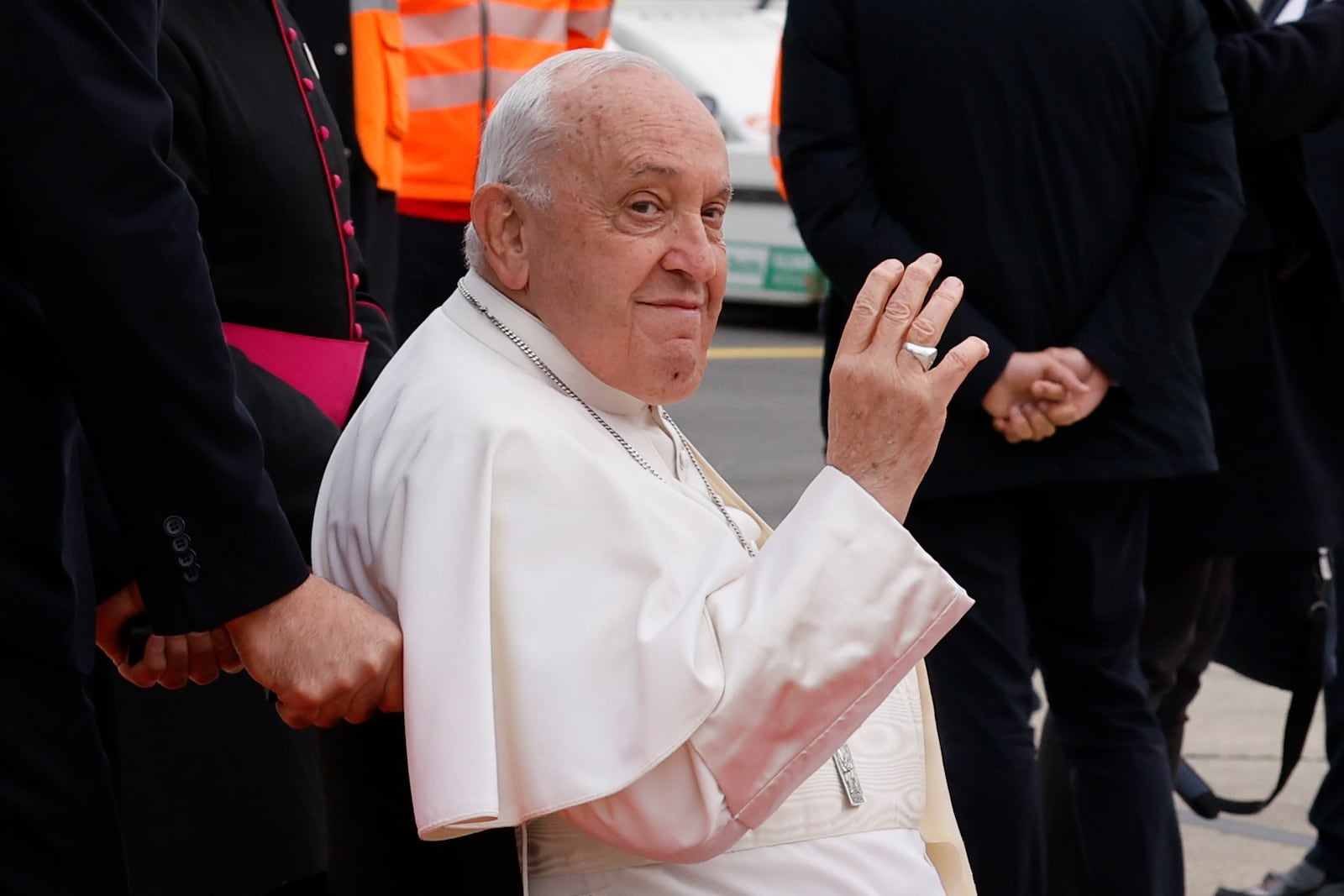 Pope Francis waves to photographers during the farewell ceremony at Melsbroek Air Base at the end of a four-day visit to Belgium and Luxembourg, Sunday, Sept. 29, 2024. (AP Photo/Geert Vanden Wijngaert)