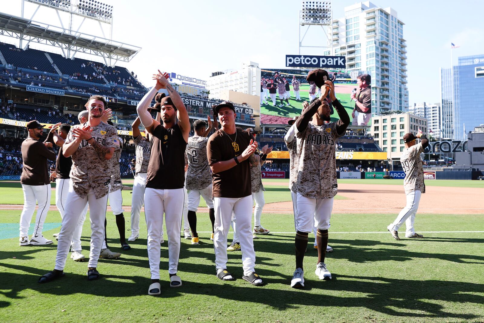 From left to right, San Diego Padres' Jackson Merrill, Tyler Wade, Adrian Morejon, and Robert Suarez acknowledge the fans after the team defeated the Chicago White Sox in a baseball game, Sunday, Sept. 22, 2024, in San Diego. (AP Photo/Derrick Tuskan)