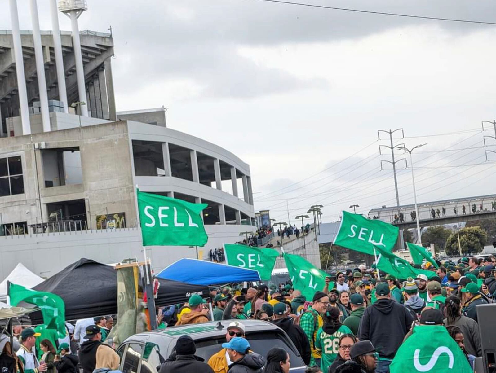 Oakland A's fan staged a rally urging team owner John Fisher to sell to a buyer who will keep the franchise in Oakland in the Coliseum parking lot on March 28, 2024 - the Opening Day of the season - in Oakland, Calif. (AP Photo/Michael Liedtke)