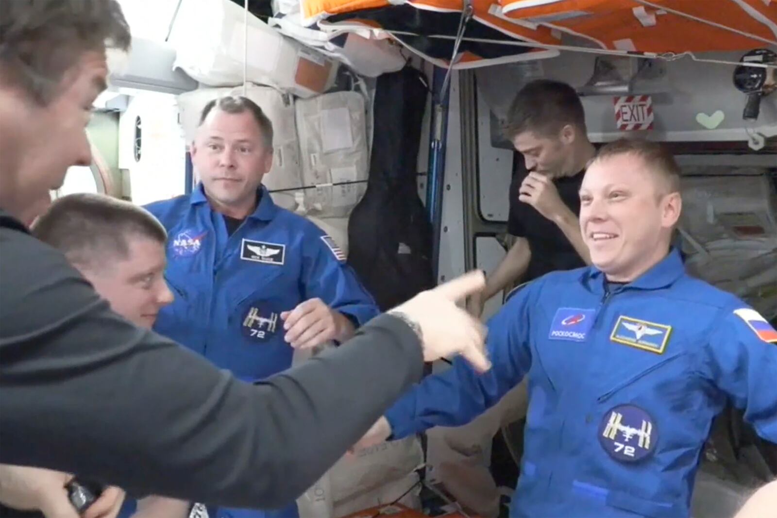 In blue suits, NASA’s Nick Hague, left, and the Russian Space Agency’s Alexander Gorbunov enter the International Space Station from the SpaceX capsule Dragon, Sunday, Sept. 29, 2024. (NASA via AP)