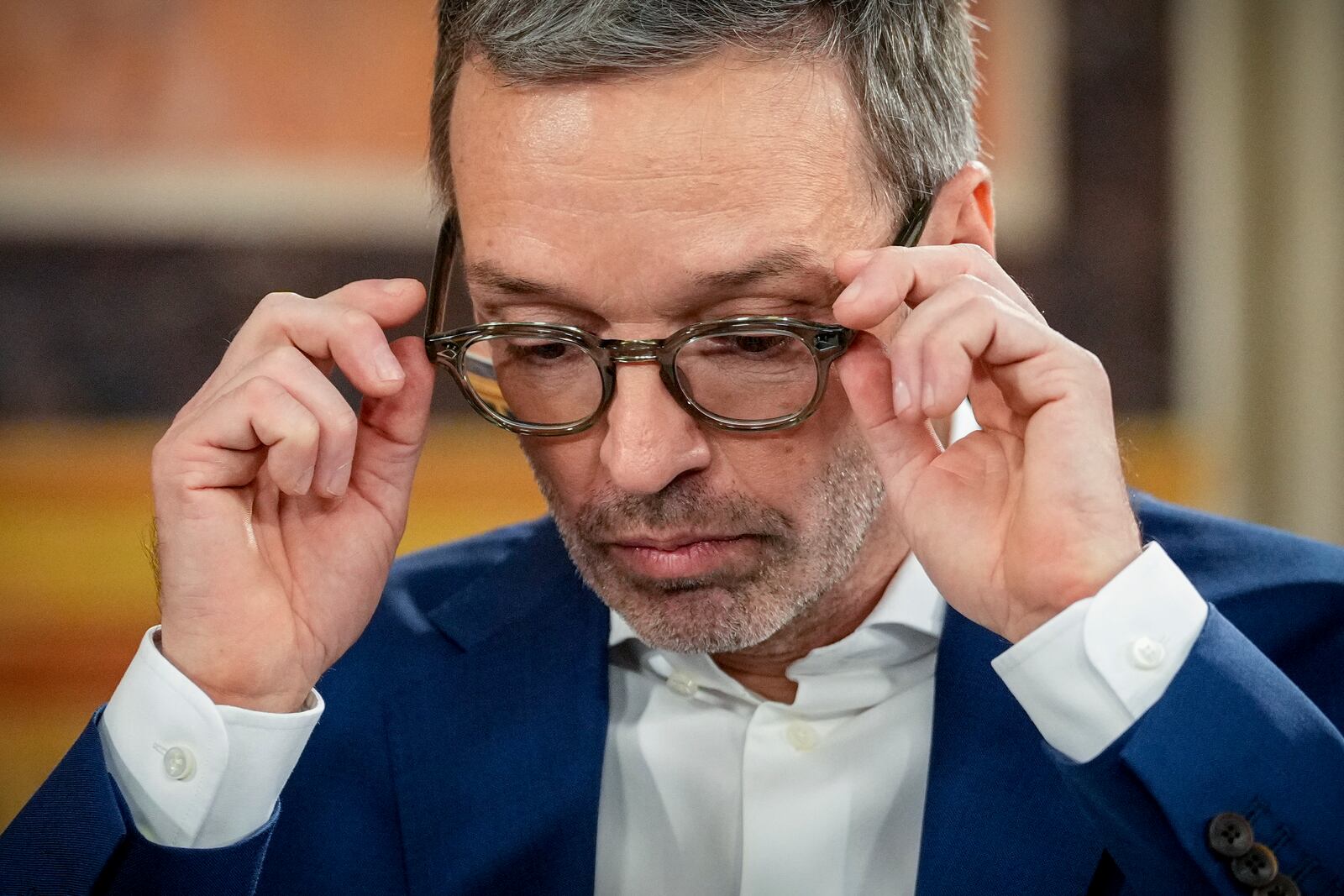 Herbert Kickl, leader of the Freedom Party of Austria adjusts his glasses at the national broadcaster studio, set up in the parliament building, in Vienna, Austria, Sunday, Sept. 29, 2024, after polls closed in the country's national election. (AP Photo/Andreea Alexandru)