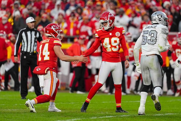 Kansas City Chiefs kicker Matthew Wright (49) celebrates with Matt Araiza (14) after a field goal against the Las Vegas Raiders during the second half of an NFL football game in Kansas City, Mo., Friday, Nov. 29, 2024. (AP Photo/Charlie Riedel)