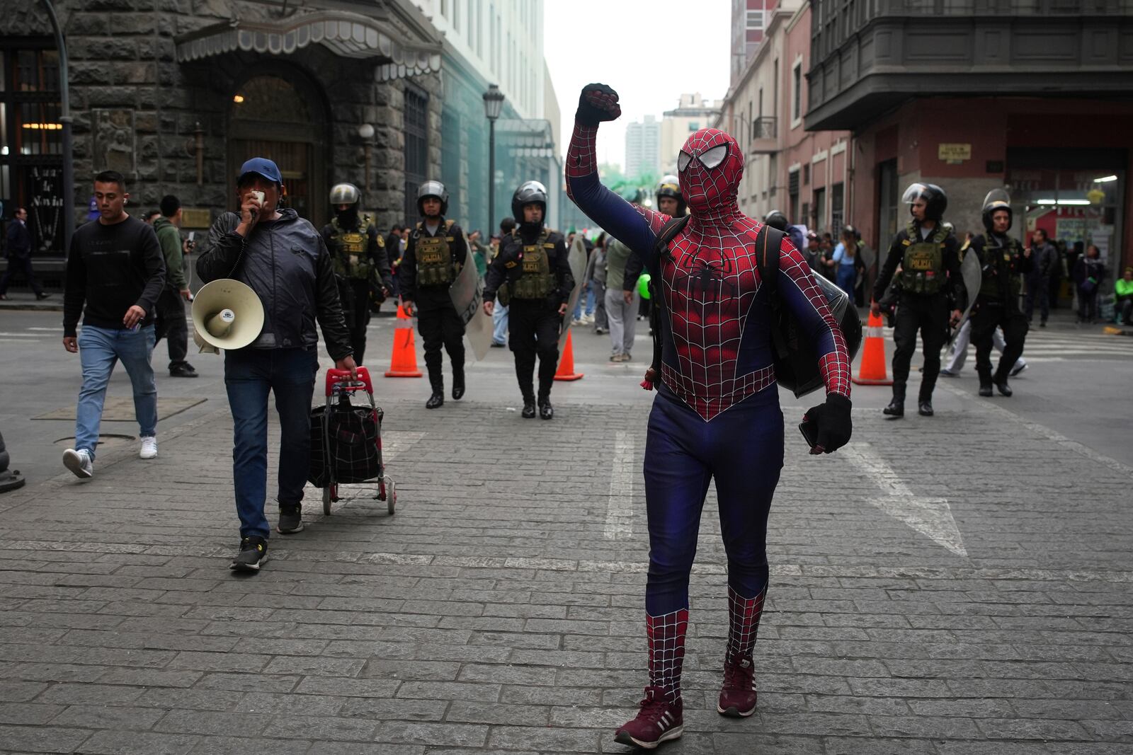 A demonstrator dressed in a Spiderman costume takes part in a march calling on the government to take stronger action to control fires in the country's Amazon region, in Lima, Peru, Wednesday, Sept. 18, 2024. (AP Photo/Guadalupe Pardo)