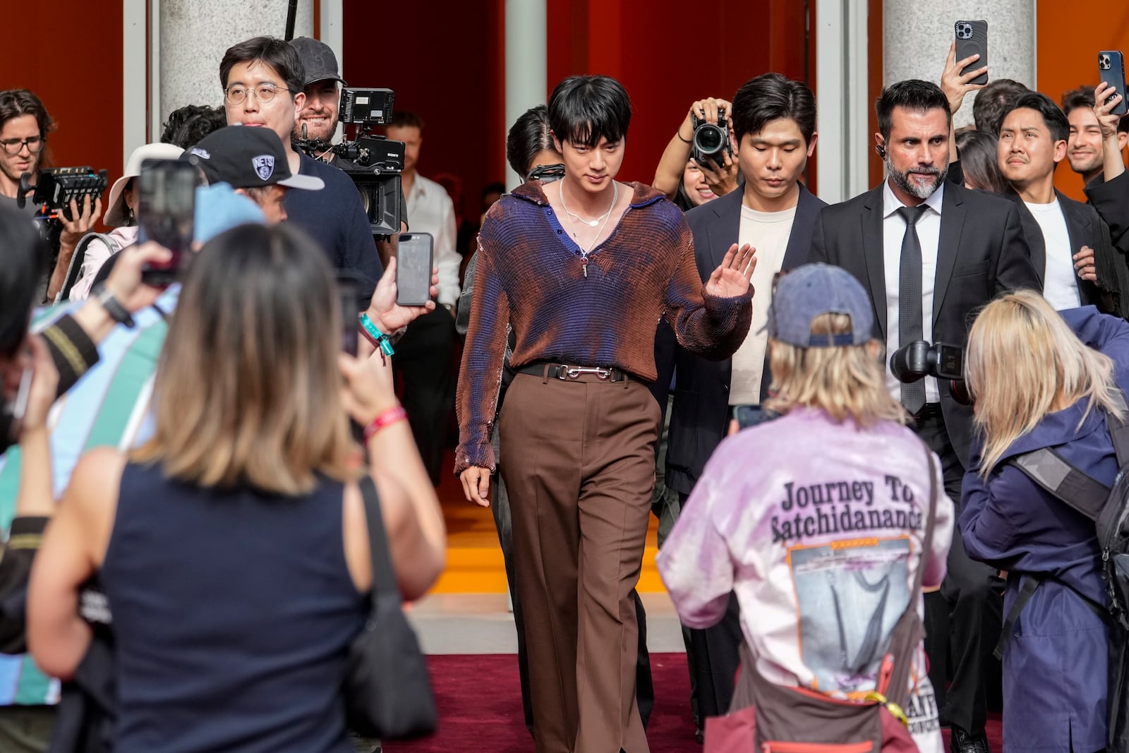 Jin departs the Gucci Spring Summer 2025 collection, that was presented in Milan, Italy, Friday, Sept. 20, 2024. (AP Photo/Luca Bruno).