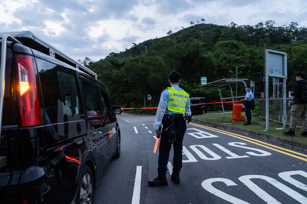 Police officers stand guard outside the Shek Pik Prison as former pro-democracy lawmaker Gary Fan, was released after four years for his conviction under the national security law in Hong Kong, Tuesday, April 29, 2025. (AP Photo/Chan Long Hei)