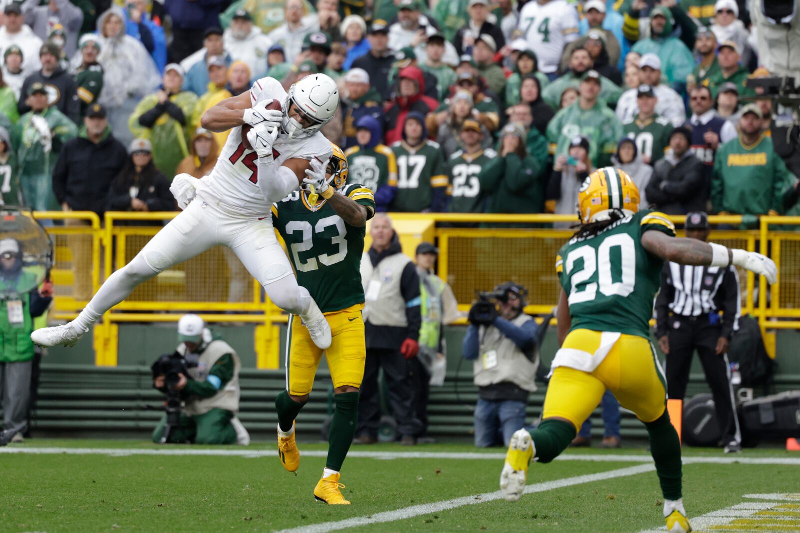 Arizona Cardinals wide receiver Michael Wilson (14), defended by Green Bay Packers cornerback Jaire Alexander (23), catches an 18-yard pass for a touchdown during the first half of an NFL football game, Sunday, Oct. 13, 2024, in Green Bay. (AP Photo/Matt Ludtke)