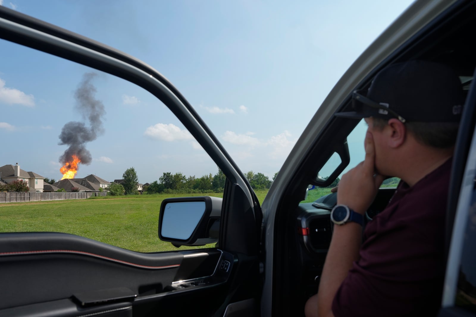 A Clear Lake man watches the pipeline fire as he is gives a ride to his friend who is a resident on E. Meadow Drive, Monday, Sept. 16, 2024 in Deer Park. . (Yi-Chin Lee/Houston Chronicle via AP)