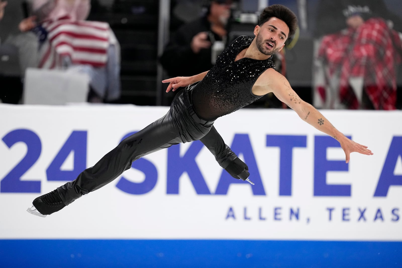 Kevin Aymoz of France competes during the men's short program at the Skate America figure skating event in Allen, Texas, Saturday, Oct. 19, 2024. (AP Photo/Tony Gutierrez)