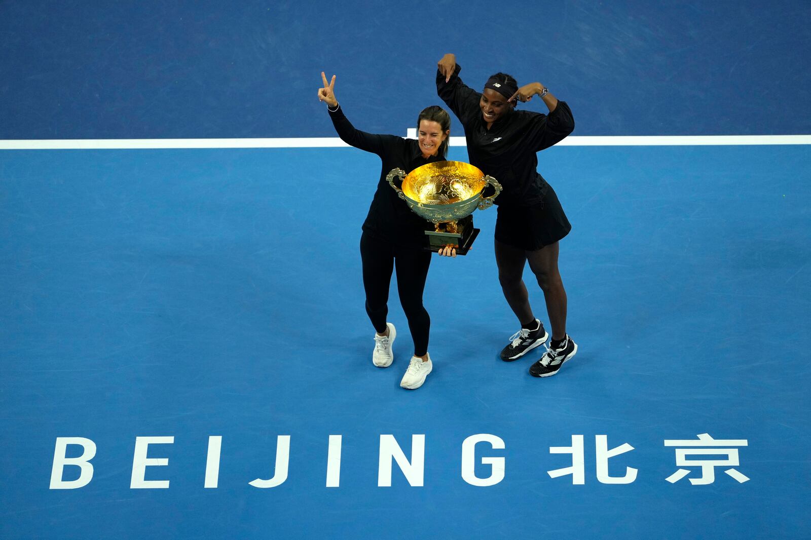 Coco Gauff of the United States celebrates with her trainer Mery Vago after defeating Karolina Muchova of Czech Republic in the women's singles final match at the China Open tennis tournament at the National Tennis Center in Beijing, Sunday, Oct. 6, 2024. (AP Photo/Ng Han Guan)