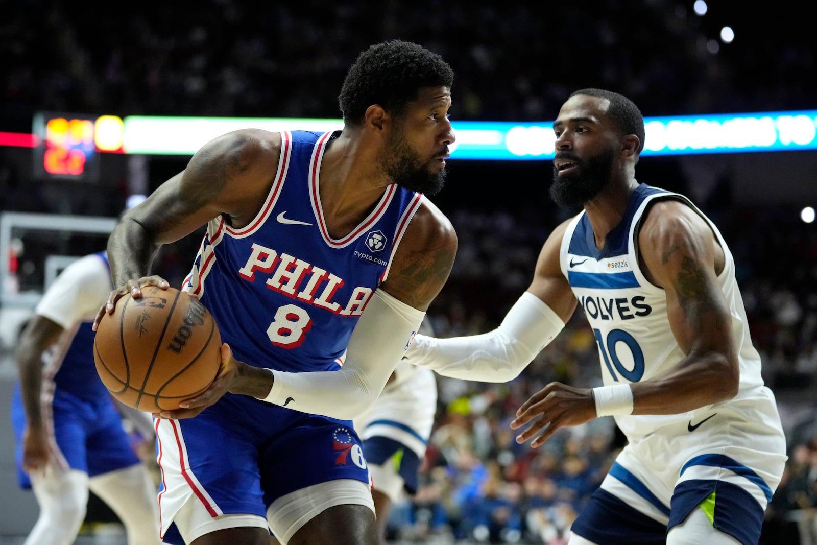 Philadelphia 76ers forward Paul George (8) looks to drive around Minnesota Timberwolves guard Mike Conley (10) during the first half of an NBA preseason basketball game, Friday, Oct. 11, 2024, in Des Moines, Iowa. (AP Photo/Charlie Neibergall)