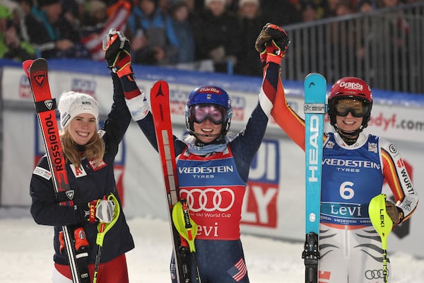 From left, second placed Austria's Katharina Liensberger, the winner United States' Mikaela Shiffrin and third placed Germany's Lena Duerr celebrate after an alpine ski, women's World Cup slalom, in Levi, Finland, Saturday, Nov. 16, 2024. (AP Photo/Marco Trovati)