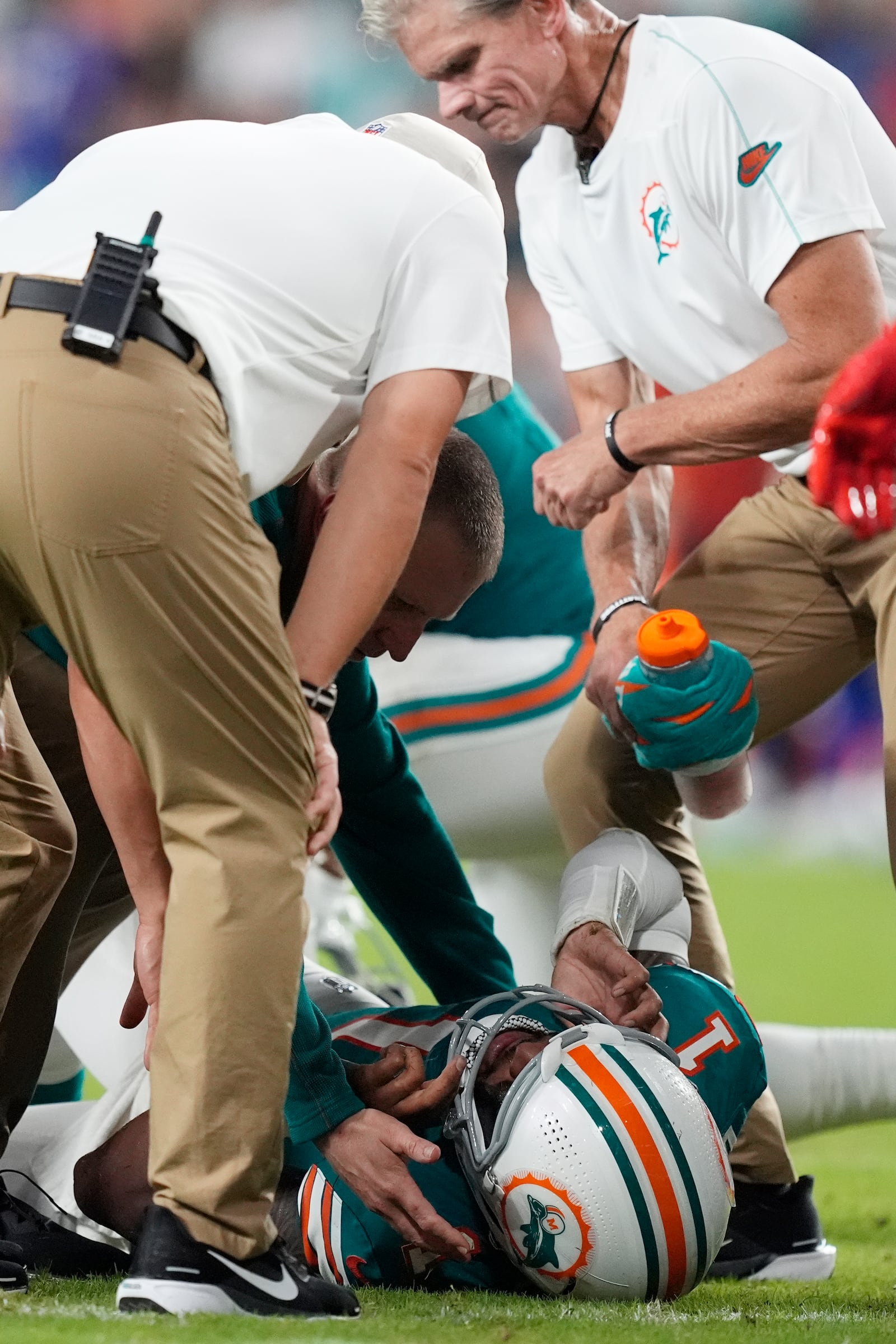 Miami Dolphins quarterback Tua Tagovailoa (1) lies on the field after suffering a concussion during the second half of an NFL football game against the Buffalo Bills, Thursday, Sept. 12, 2024, in Miami Gardens, Fla (AP Photo/Rebecca Blackwell)