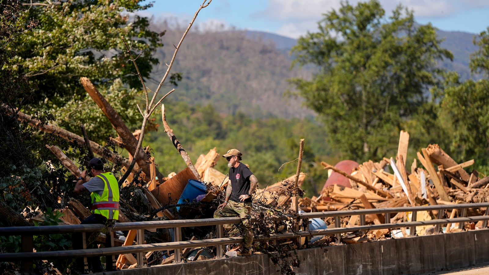 Debris rests on a bridge in the aftermath of Hurricane Helene, Wednesday, Oct. 2, 2024, in Chimney Rock Village, N.C. (AP Photo/Mike Stewart)