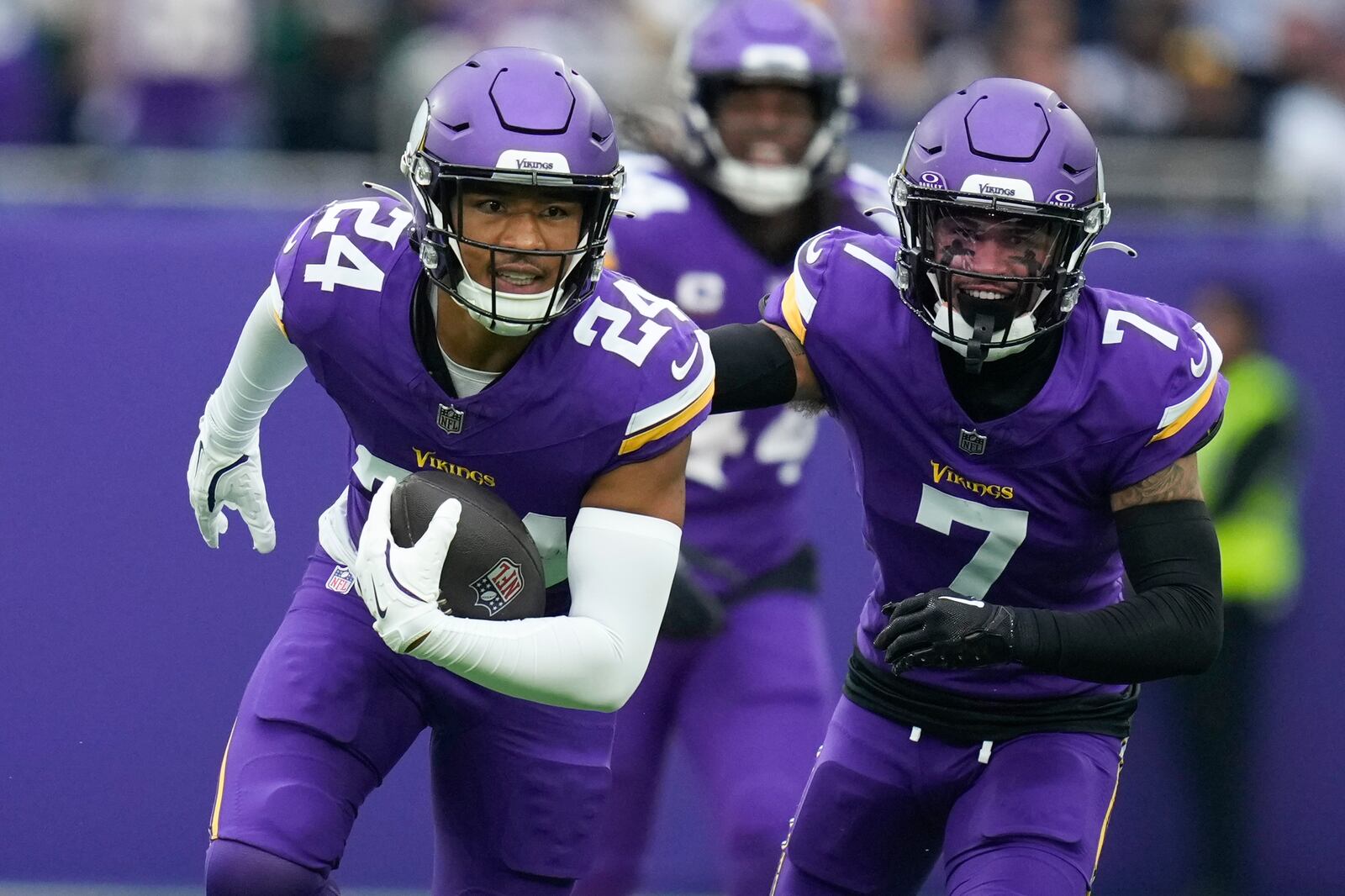 Minnesota Vikings' Camryn Bynum, left, celebrates an interception during the first half of an NFL football game against the New York Jets, Sunday, Oct. 6, 2024, at the Tottenham Hotspur stadium in London. (AP Photo/Kirsty Wigglesworth)