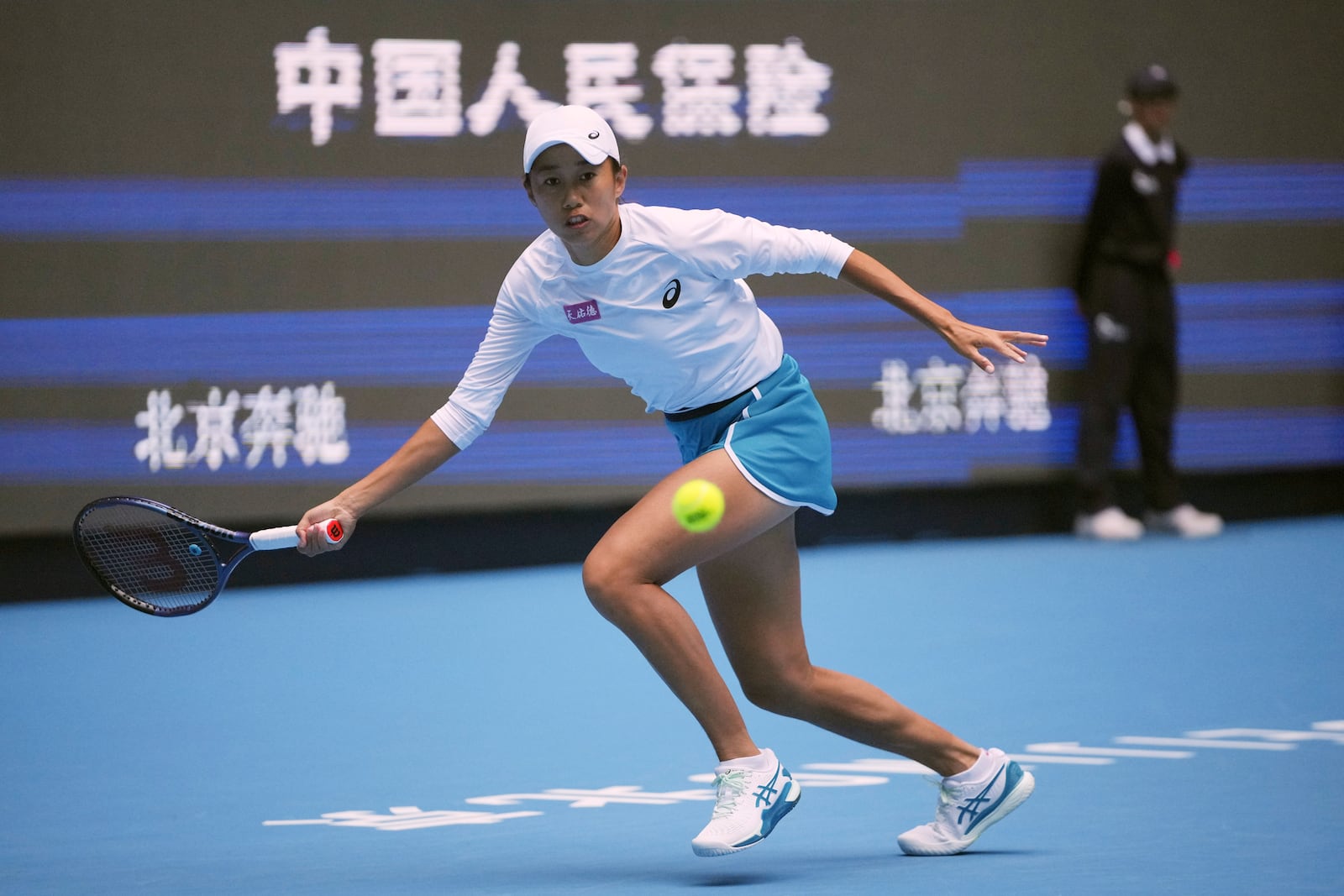 Zhang Shuai of China eyes the ball during against Magdalena Frech of Poland in women's singles match for the China Open tennis tournament at the national tennis center in Beijing, Tuesday, Oct. 1, 2024. (AP Photo/Achmad Ibrahim)