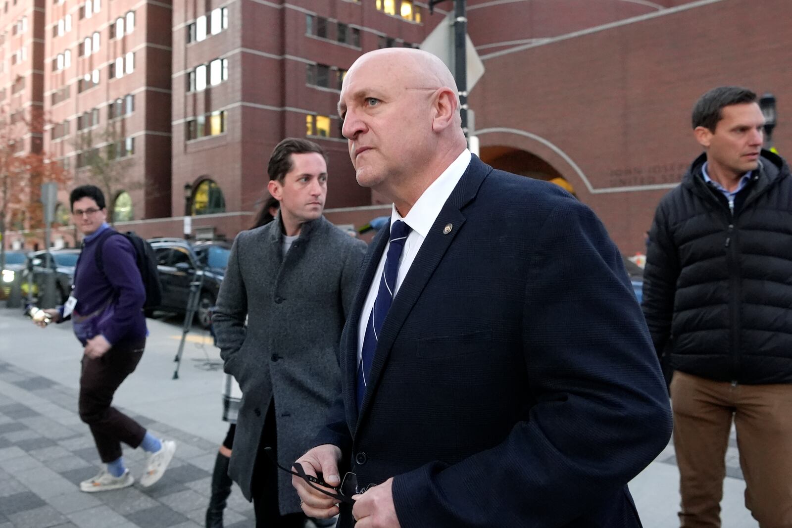 Thomas Dufault, front, stepfather of Massachusetts Air National Guardsman Jack Teixeira, departs federal court, Tuesday, Nov. 12, 2024, in Boston, following a sentencing hearing for Jack Teixeira. (AP Photo/Steven Senne)