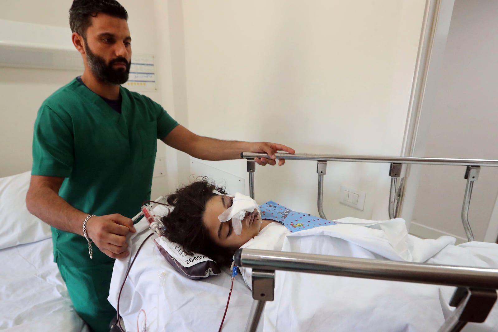 Fatima Abdel Rahman Zorout, 7, who was wounded in an Israeli airstrike, is wheeled on a gurney at the Alaaeddine Hospital in Sarafand, south Lebanon, Thursday, Sept. 26, 2024. (AP Photo/Mohammed Zaatari)