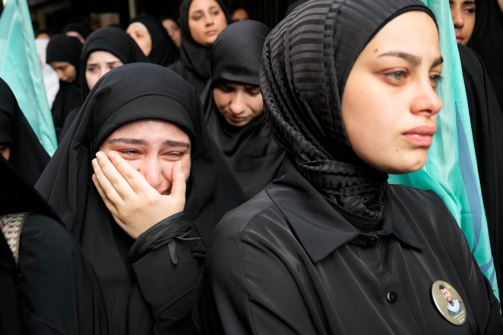 A girl cries during the funeral procession of two Hezbollah members, killed on Wednesday when a handheld device exploded, in the southern suburbs of Beirut, Thursday, Sept. 19, 2024. (AP Photo/Hussein Malla)