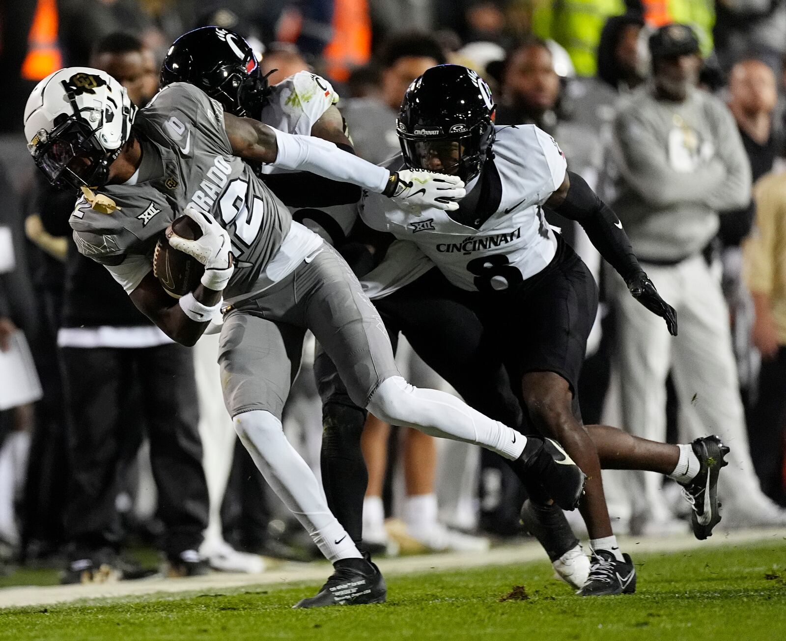 Colorado wide receiver Travis Hunter, front, is tackled by Cincinnati defensive back Derrick Canteen and cornerback Ormanie Arnold in the first half of an NCAA college football game Saturday, Oct. 26, 2024, in Boulder, Colo. (AP Photo/David Zalubowski)