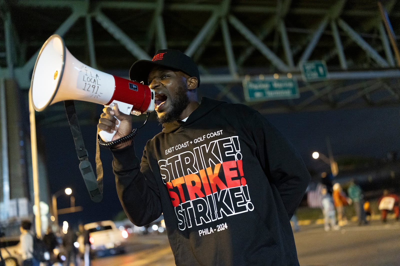 Third generation longshoreman Ray Bailey Jr. trustee of ILA Local 1291 encourages picketers outside the Packer Avenue Marine Terminal Port, Tuesday, Oct. 1, 2024.(AP Photo/Ryan Collerd)