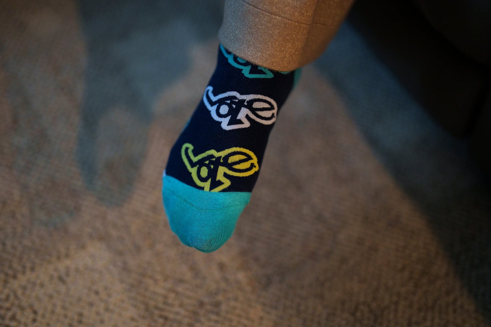 Cari-Ann Burgess, interim Registrar of Voters for Washoe County, Nev., wears socks with the word "vote" while sitting at her home Friday, Sept. 20, 2024, in Reno, Nev. (AP Photo/John Locher)