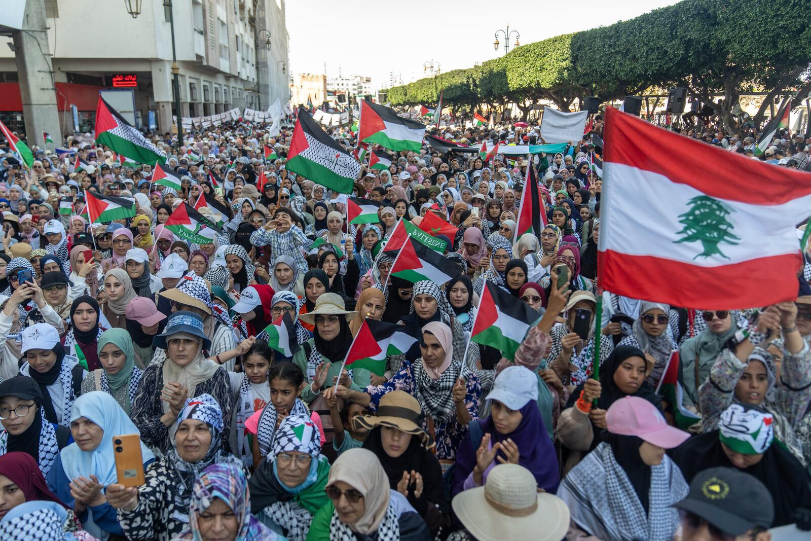 Women wave flags and chant slogans in support of Gaza and Lebanon during a protest in Rabat, Morocco, Sunday, Oct. 6, 2024 (AP Photo/Mosa'ab Elshamy)