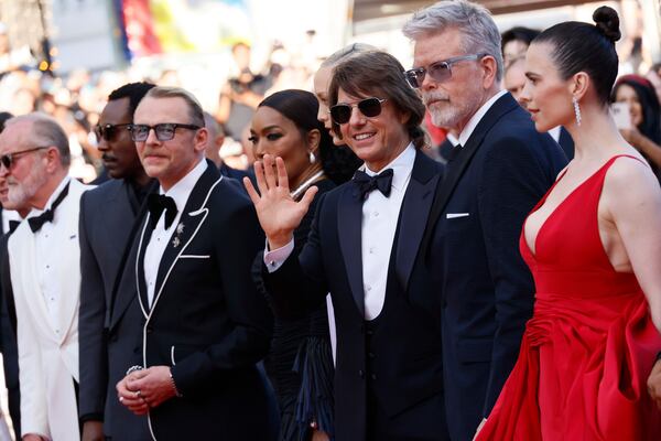 Writer Erik Jendresen, from left, Tramell Tillman, Simon Pegg, Angela Bassett, Pom Klementieff, Tom Cruise, director Christopher McQuarrie and Hayley Atwell pose for photographers upon arrival at the premiere of the film 'Mission: Impossible - The Final Reckoning' at the 78th international film festival, Cannes, southern France, Wednesday, May 14, 2025. (Photo by Joel C Ryan/Invision/AP)