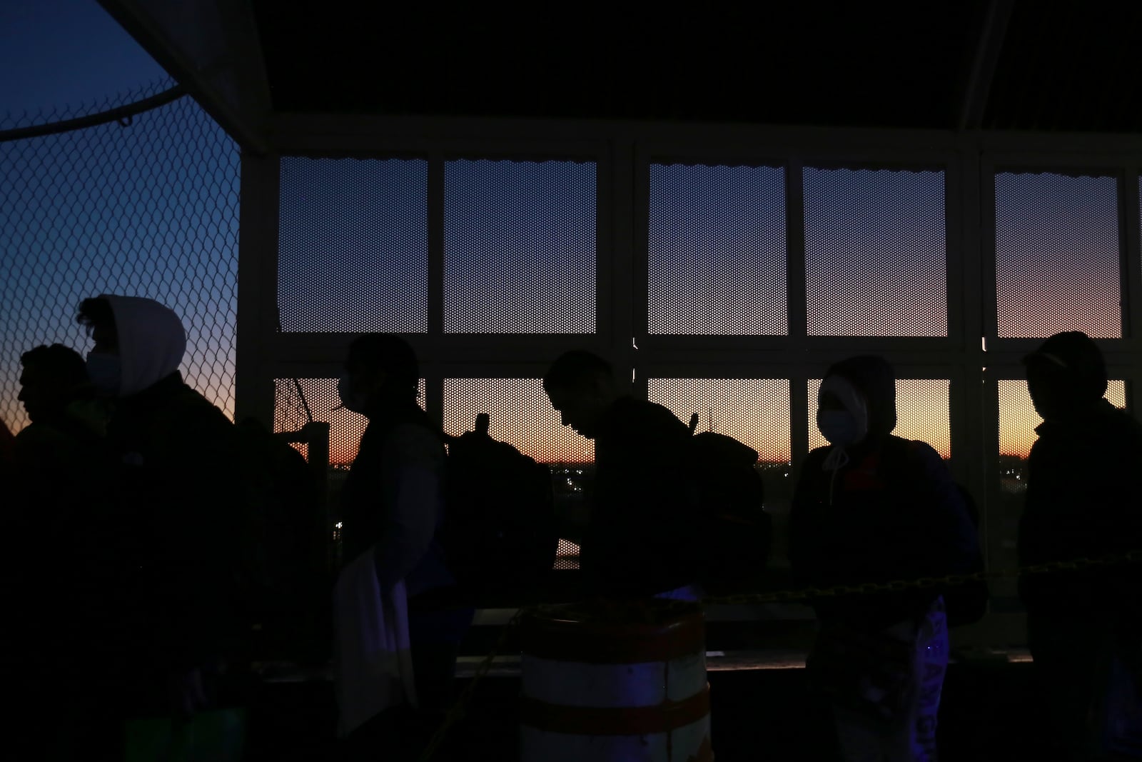 Migrants line up to present to U.S. agents documents requesting appointment to apply for asylum at the Paso del Norte international bridge, in Ciudad Juarez, Mexico, Tuesday Nov 5, 2024. (AP Photo/Christian Chavez)