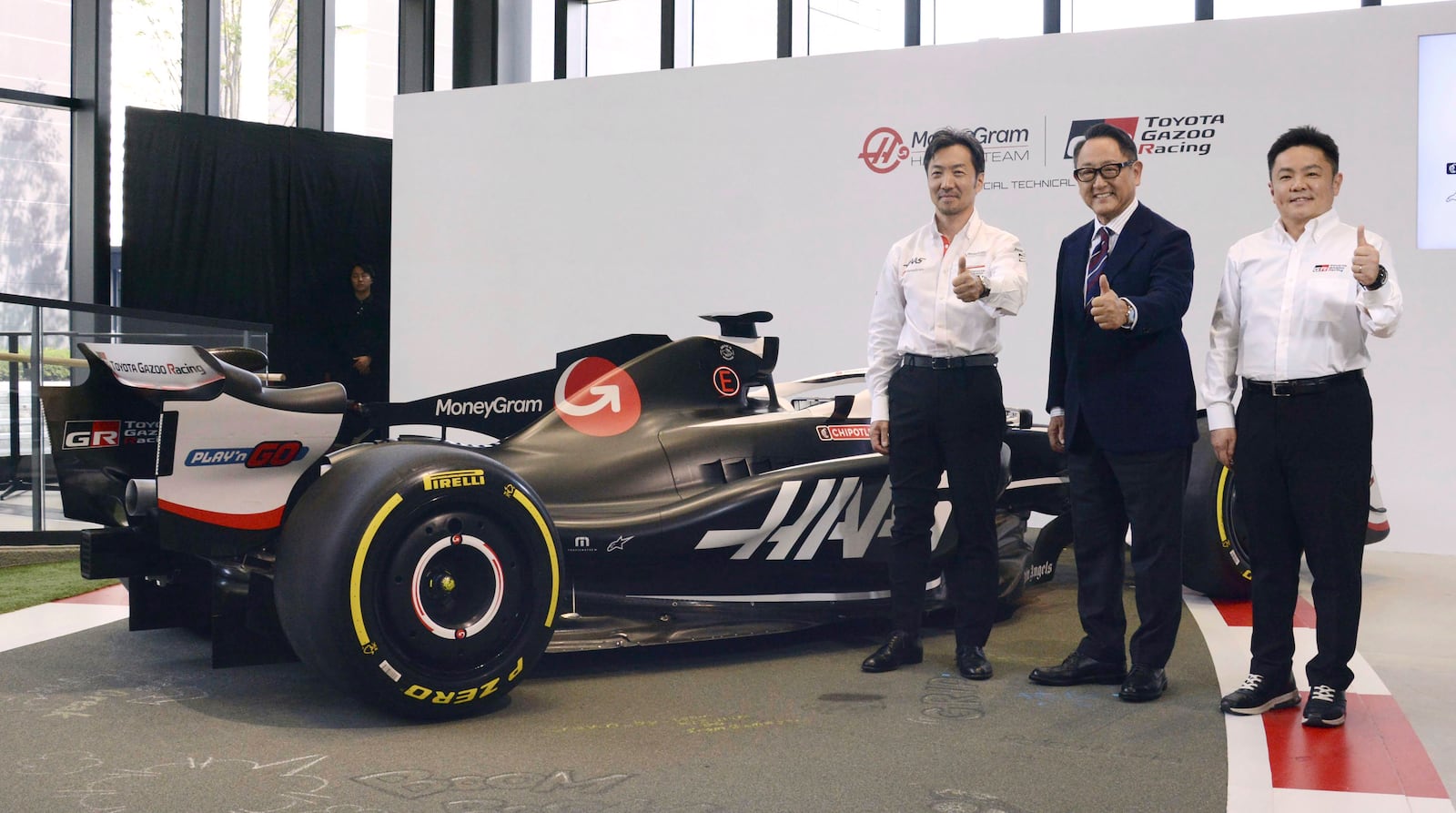 Toyota Chairman Aiko Toyoda, center, with Ayao Komatsu, left, Team Principal of MoneyGram Haas F1 Team and Tomoya Takahashi, President of GAZOO Racing Company, poses for a photo in Oyama, Shizuoka prefecture, Japan, Friday, Oct. 11, 2024. (Kyodo News via AP)