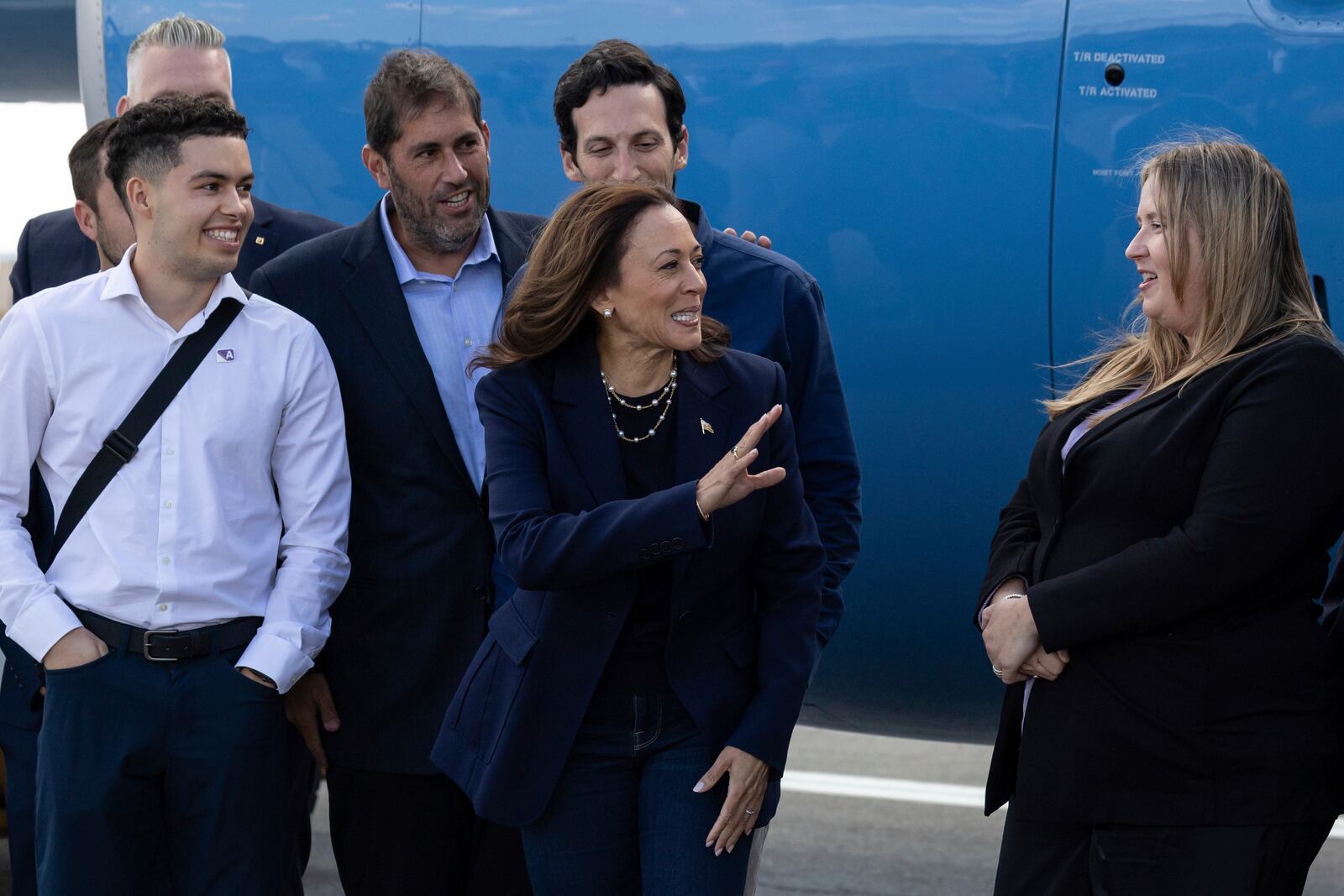 Democratic presidential nominee Vice President Kamala Harris waves at volunteers as she boards Air Force Two at LaGuardia International Airport, Wednesday, Oct. 9, 2024, in New York. (AP Photo/Yuki Iwamura)