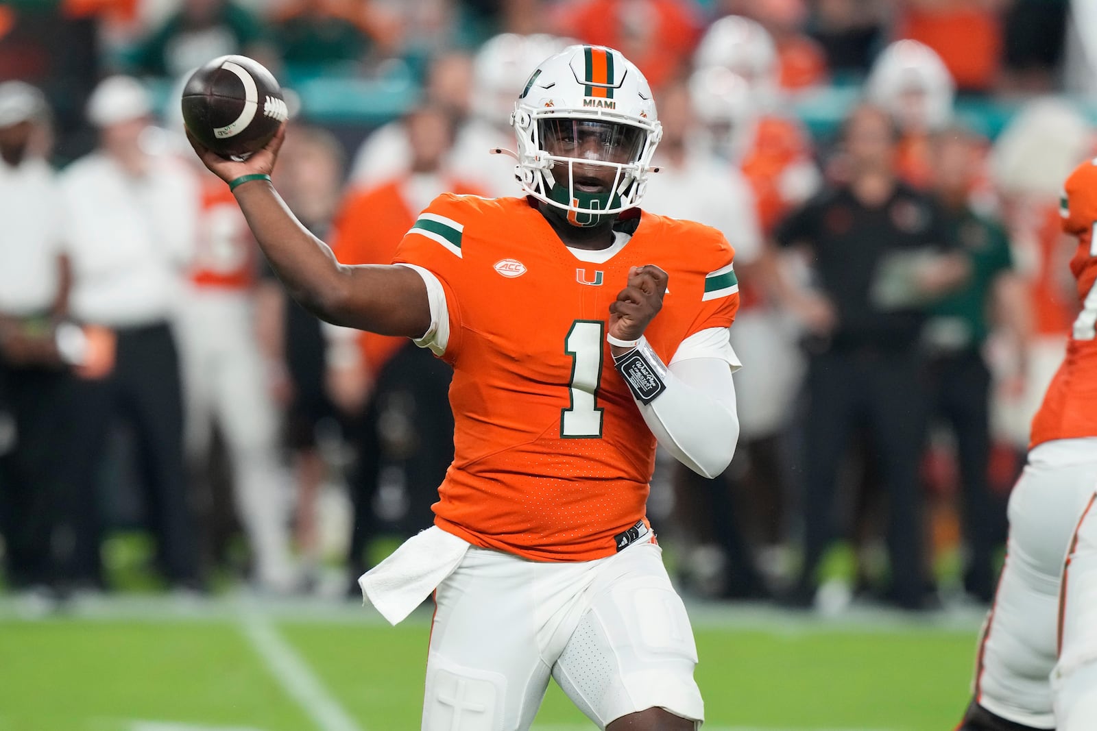 Miami quarterback Cam Ward (1) aims a pass during the first half of an NCAA college football game against Virginia Tech, Friday, Sept. 27, 2024, in Miami Gardens, Fla. (AP Photo/Marta Lavandier)