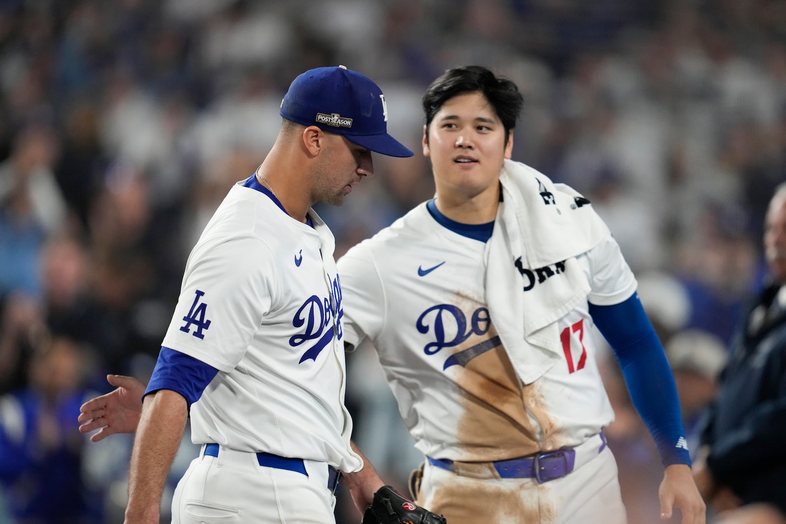 Los Angeles Dodgers pitcher Jack Flaherty, left, is greeted by Shohei Ohtani as he returns to the dugout during the seventh inning in Game 1 of a baseball NL Championship Series against the New York Mets, Sunday, Oct. 13, 2024, in Los Angeles. (AP Photo/Ashley Landis)