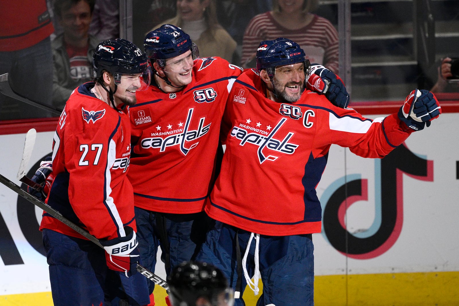 Washington Capitals left wing Alex Ovechkin, right, celebrates his goal with center Aliaksei Protas (21) and defenseman Alexander Alexeyev (27) during the third period of an NHL hockey game against the Montreal Canadiens, Thursday, Oct. 31, 2024, in Washington. The Capitals won 6-3. (AP Photo/Nick Wass)