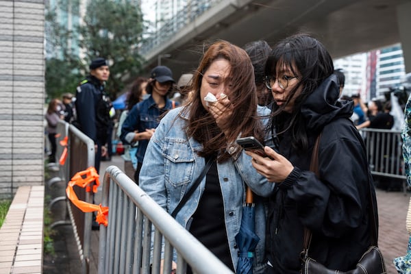 People leave the West Kowloon Magistrates' Courts in Hong Kong Tuesday, Nov. 19, 2024, following the sentencing in national security case. (AP Photo/Chan Long Hei)